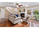 Inviting living room with fireplace, hardwood floors, ceiling fan and natural light at 2891 S Vaughn Way, Aurora, CO 80014