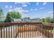 View from the deck of the backyard with a shed and wood fence, under a bright, partly cloudy sky at 12702 Fairfax St, Thornton, CO 80241