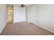 Inviting bedroom with neutral carpet, double closets, and an open doorway to an adjoining bathroom at 12702 Fairfax St, Thornton, CO 80241