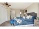 Beautiful bedroom featuring a plush blue bed, ceiling fan, carpet, and neutral paint, offering a cozy retreat at 12702 Fairfax St, Thornton, CO 80241