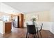 Cozy dining area featuring wood floors, wainscoting, and stainless steel appliances in the adjacent kitchen at 12702 Fairfax St, Thornton, CO 80241