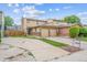 Charming two-story home with a two car garage, brick accents, and a well maintained front yard at 12702 Fairfax St, Thornton, CO 80241