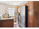 Bright kitchen with wood cabinets, stainless steel appliances, and a granite countertop at 12702 Fairfax St, Thornton, CO 80241