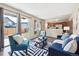 Inviting living room with modern furnishings, a sliding glass door to the backyard, and open to the kitchen at 12702 Fairfax St, Thornton, CO 80241