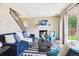 Cozy living room with a fireplace, staircase, sliding glass door, and neutral walls at 12702 Fairfax St, Thornton, CO 80241