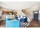 Bright living room with a staircase, open to the kitchen, featuring a modern black and white rug at 12702 Fairfax St, Thornton, CO 80241