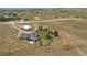 Aerial shot of a ranch property in a rural setting, showcasing the home, garage, and surrounding land at 1143 Belgian Trl, Elizabeth, CO 80107