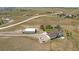 An aerial view captures the home and its detached garage on its expansive lot with a vehicle parked nearby at 1143 Belgian Trl, Elizabeth, CO 80107