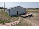 Barn exterior showing access door and trailer on the property at 1143 Belgian Trl, Elizabeth, CO 80107