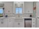 Bright kitchen with modern farmhouse sink, white cabinets, and stainless steel appliances at 1143 Belgian Trl, Elizabeth, CO 80107