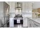 Contemporary kitchen featuring stainless steel appliances, white cabinets, and stylish backsplash at 1143 Belgian Trl, Elizabeth, CO 80107
