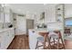 Modern kitchen with white cabinetry, stainless steel appliances, and breakfast bar seating at 1143 Belgian Trl, Elizabeth, CO 80107