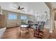 Living room with two recliners, hardwood floors, a ceiling fan, access to the basement and views to the outside at 1143 Belgian Trl, Elizabeth, CO 80107