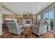 Comfortable living room with hardwood floors, stone fireplace, fan, and sliding door to the outside at 1143 Belgian Trl, Elizabeth, CO 80107