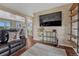 Living room showcasing hardwood floors, a modern entertainment setup, and an open layout with seamless flow at 1143 Belgian Trl, Elizabeth, CO 80107