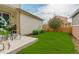 Backyard featuring a well-maintained lawn, patio, and wooden privacy fence at 540 E Fremont Pl, Centennial, CO 80122