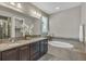 Luxurious bathroom featuring a double vanity, soaking tub, and designer tile work at 540 E Fremont Pl, Centennial, CO 80122