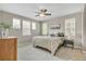 Comfortable bedroom with neutral tones, multiple windows, a ceiling fan, and plush bedding for a serene retreat at 540 E Fremont Pl, Centennial, CO 80122