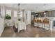 Cozy dining area features modern pendant lighting, sleek wood floors and an adjacent kitchen with bar stool seating at 540 E Fremont Pl, Centennial, CO 80122