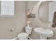 Charming half bathroom featuring a modern vanity, round mirror, and a quaint pig art print, offering a touch of whimsy at 540 E Fremont Pl, Centennial, CO 80122
