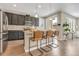 Modern kitchen featuring dark cabinetry, stainless steel appliances, and a stylish island with seating at 540 E Fremont Pl, Centennial, CO 80122
