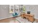 Bright office with hardwood floors, complemented by a modern desk, stylish seating, and natural light from multiple windows at 540 E Fremont Pl, Centennial, CO 80122