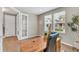 Well-lit office space featuring a wooden desk, and large windows, with a partial view of the neighborhood and the home's exterior at 540 E Fremont Pl, Centennial, CO 80122