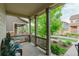 Relaxing covered porch with wicker furniture and a view of the landscaped courtyard at 540 E Fremont Pl, Centennial, CO 80122