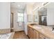 Bright bathroom featuring a soaking tub, glass shower, and vanity at 14247 W 84Th Cir # A, Arvada, CO 80005