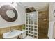 Well-lit bathroom featuring unique glass block partition and modern fixtures at 14247 W 84Th Cir # A, Arvada, CO 80005