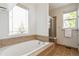 Bright bathroom with a soaking tub and a separate glass shower at 14247 W 84Th Cir # A, Arvada, CO 80005