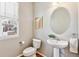 Cozy powder room with a pedestal sink and modern fixtures at 14247 W 84Th Cir # A, Arvada, CO 80005