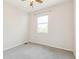 Clean bedroom with gray carpet, ceiling fan, and natural light at 14247 W 84Th Cir # A, Arvada, CO 80005