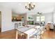 Open dining area with a modern chandelier, flowing into the living room and kitchen spaces at 14247 W 84Th Cir # A, Arvada, CO 80005