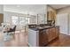 Well-lit kitchen featuring modern appliances, hardwood floors, and an open layout leading to the dining area at 14247 W 84Th Cir # A, Arvada, CO 80005
