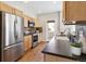 Contemporary kitchen with stainless appliances, wood cabinets, and a view to the door with a lovely view at 14247 W 84Th Cir # A, Arvada, CO 80005