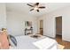 Comfortable bedroom featuring neutral tones, a ceiling fan, and an ensuite bath at 14247 W 84Th Cir # A, Arvada, CO 80005