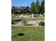 Picturesque water fountain surrounded by lush greenery, walking paths, and landscaping at 14247 W 84Th Cir # A, Arvada, CO 80005