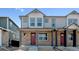 Charming townhome with stone accents, gray siding, and a welcoming front porch at 18724 E 99Th Ave, Commerce City, CO 80022