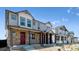 Row of modern townhomes featuring inviting front porches and attractive landscaping at 18724 E 99Th Ave, Commerce City, CO 80022