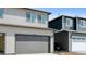 Two-car garage featuring neutral siding, a concrete driveway, and a well-maintained facade at 18724 E 99Th Ave, Commerce City, CO 80022