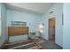 Comfortable bedroom featuring a wooden bed frame, light blue walls, and a beach-themed artwork at 3096 W Prentice Ave # G, Littleton, CO 80123