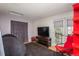 This bedroom is complete with a large tv, balcony access and large, comfortable beanbag chair at 3096 W Prentice Ave # G, Littleton, CO 80123