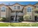 Inviting condo showcasing a manicured lawn, two-story facade, private balconies, and a warm, neutral color palette at 3096 W Prentice Ave # G, Littleton, CO 80123