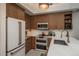 This kitchen features sleek, wood grain cabinets, modern appliances, and quartz countertops at 3096 W Prentice Ave # G, Littleton, CO 80123