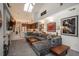 Open-concept living area with a modern fireplace, TV, and seamless flow to the kitchen perfect for entertaining and relaxation at 3096 W Prentice Ave # G, Littleton, CO 80123
