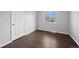 This bedroom has hardwood floors, a window, and a white door, offering a cozy retreat at 10280 W 8Th Ave, Lakewood, CO 80215