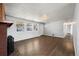 Spacious living room featuring a brick fireplace, wood floors, and abundant natural light at 10280 W 8Th Ave, Lakewood, CO 80215
