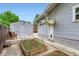 Private backyard with raised garden beds, gray-tone siding, a detached garage, and wood fence at 4057 Bryant St, Denver, CO 80211