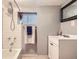 Bathroom with shower over tub, subway tile surround, vanity, and modern fixtures at 4057 Bryant St, Denver, CO 80211